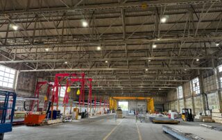 Interior of converted aircraft hangar with Avix bird control units protecting modular building facility from pigeons