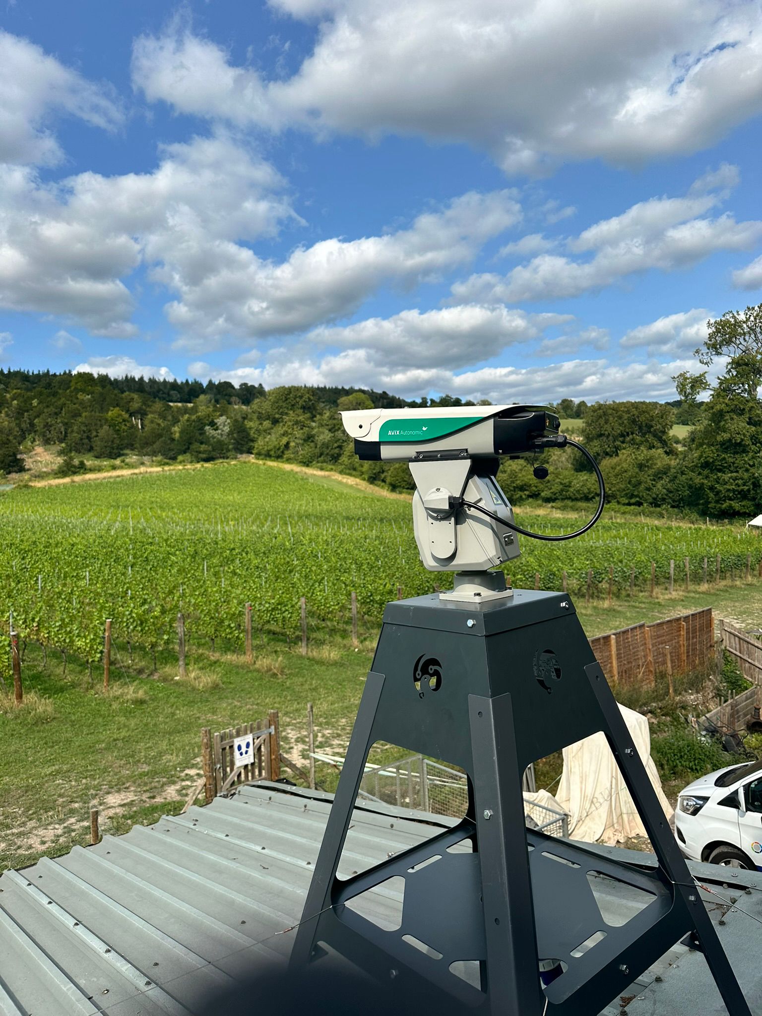 WhatsApp Image 2025-08-22 at 17.07.27 (2) Avix Autonomic bird control unit on rooftop stand safeguarding Guildford vineyard vines from bird damage