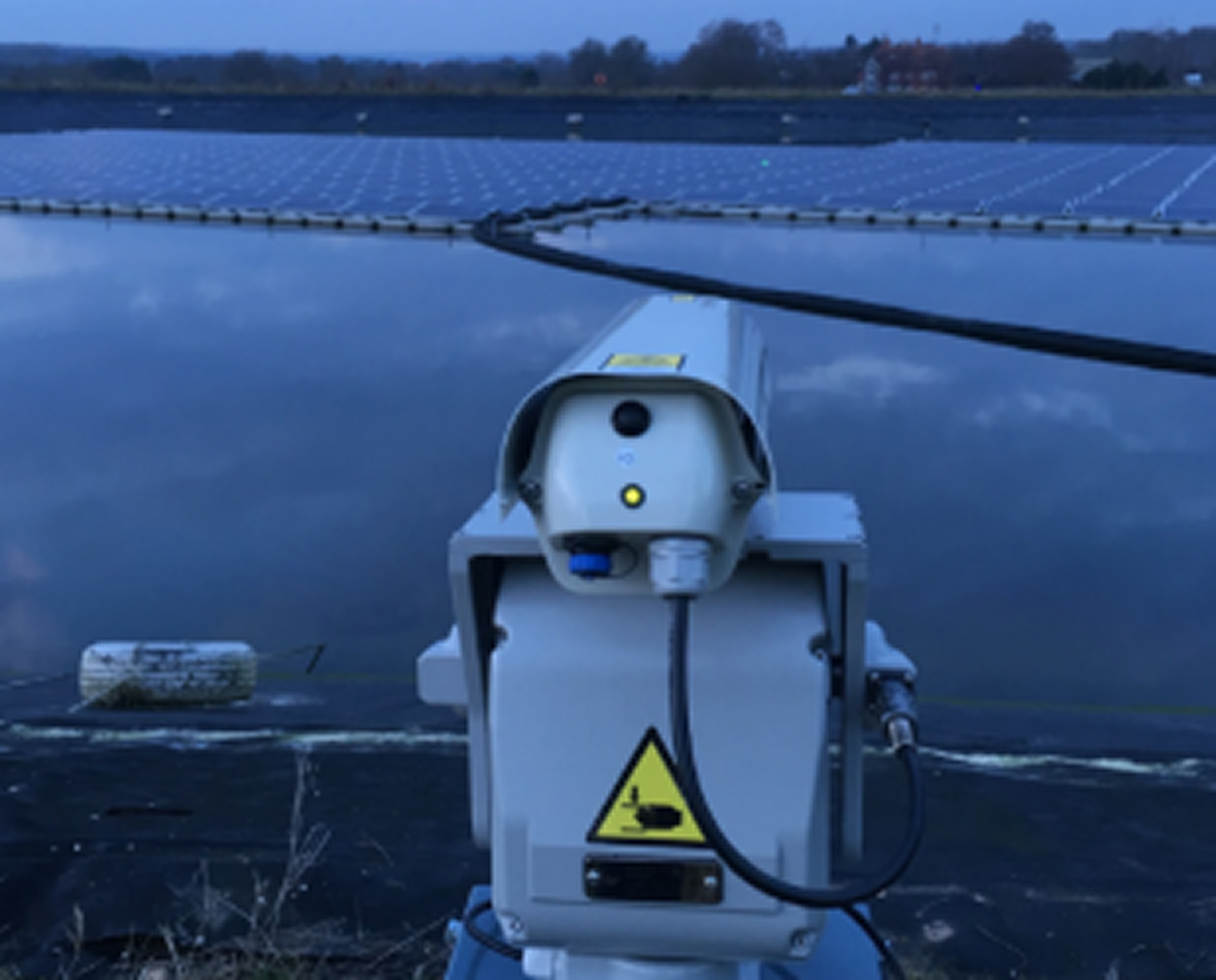 Agrilaser Autonomic bird deterrent system installed on floating solar panel platform at Sheeplands Farm reservoir in Berkshire, UK.