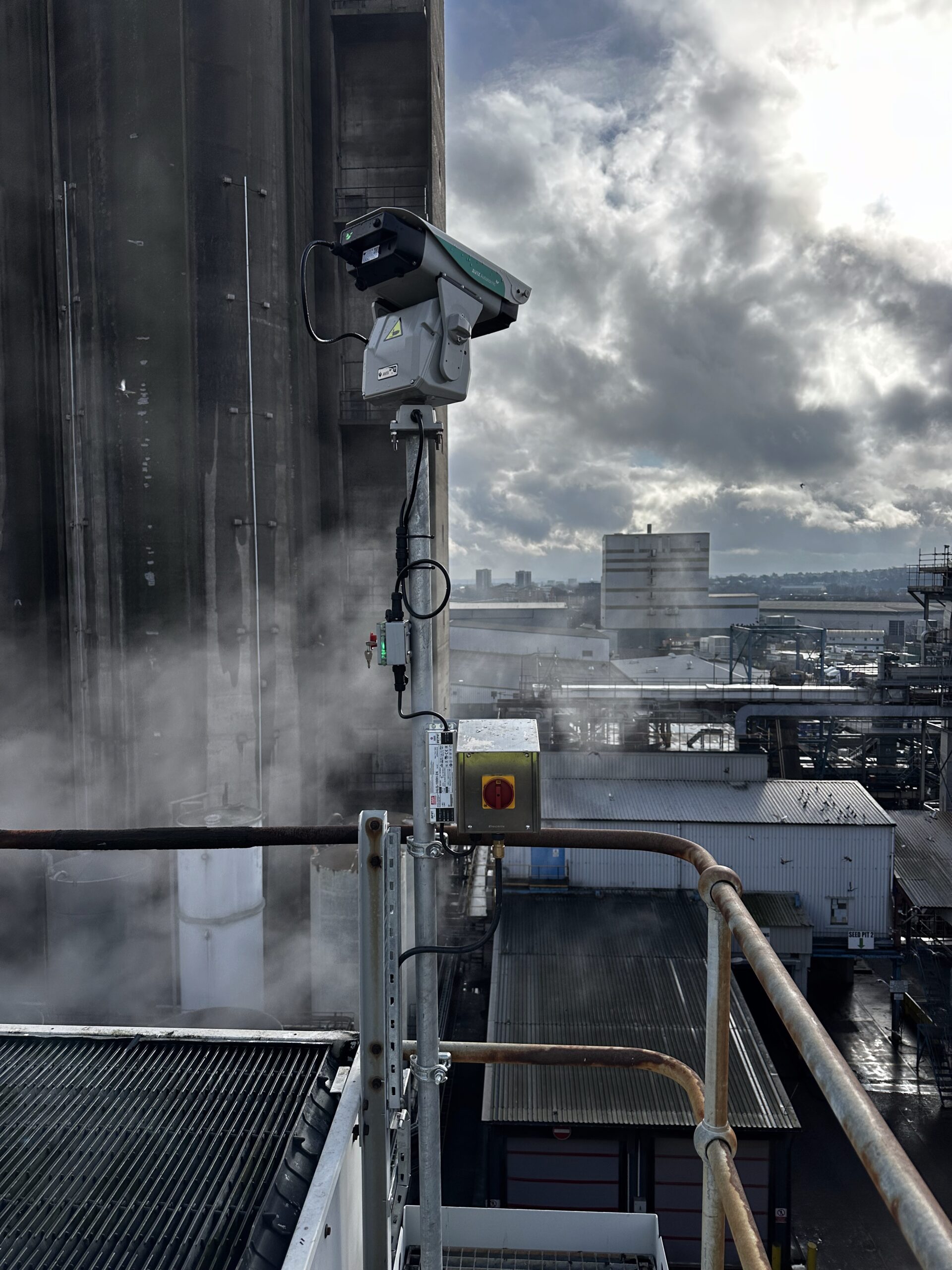 Avix Autonomic Mark II laser bird deterrent mounted on pole at height on grain processing facility, Dartford